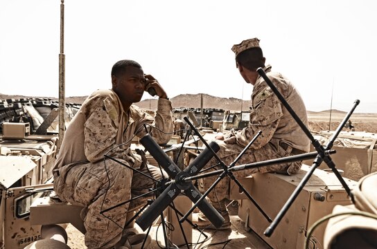 Cpl. David C. Avery III, radio operator, Alpha Company, Combat Logistics Battalion 4, 1st Marine Logistics Group (Forward), establishes communications with battalion headquarters from a forward rearming, refueling and resupply point, May 29. Avery provided communication support to CLB-4 during Operation Branding Iron.