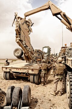 Marines with Alpha Company, Combat Logistics Battalion 4, 1st Marine Logistics Group (Forward), recover a damaged mineroller during a combat logistics patrol in Helmand Province, May 30. The mineroller was damaged while traversing the rough terrain north of Musa Qal’ah in support of Operation Branding Iron.