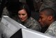 1st Lt. Amanda Elliott and Capt. Allen Batiste, both from the U.S. Air Forces Central Command Air Mobility Division airlift control team in Southwest Asia, review movement plans for aircraft Oct. 15, 2012, at the Combined Air and Space Operations Center AMD work section. While aircrews and aircraft do the “heavy lifting” of transporting passengers from one point to another, AMD plans and coordinates each movement within the theater, ensuring the success of all mobility operations. (U.S. Air Force photo/Tech. Sgt. Mike Andriacco)