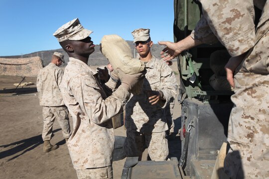 Marines with 7th Engineer Support Battalion, 1st Marine Logistics Group, load sandbags into a vehicle during a field training exercise at Camp Pendleton, Calif., Oct. 15.