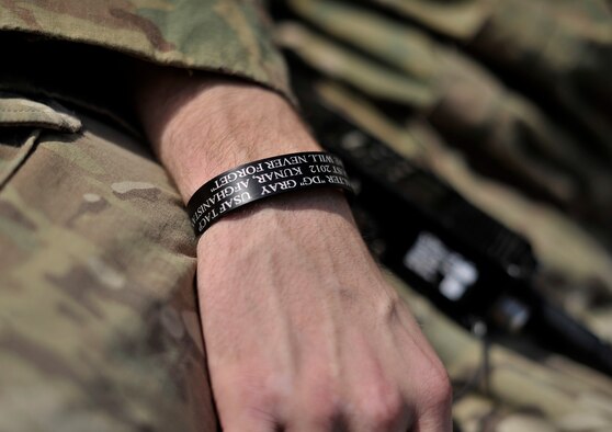 U.S. Air Force Airman 1st Class Tommy Allgier, Tactical Air Control Party member, wears a killed in action bracelet in memory of Maj. Walter Gray, who was KIA during a mission on Aug. 8, 2012. Gray was a fellow Joint Terminal Attack Controller and an Air Liaison Officer. The JTACs and TACP members that were under Gray's command wear the bracelets in memory of their fallen leader, who had a strong and lasting connection with his troops. (U.S. Air Force photo/Staff Sgt. Clay Lancaster)