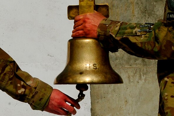 U.S. Air Force Senior Amn Robert Tisdale, left, rings the bell while Senior Master Sgt. Eduardo Beltran, right, holds it during the September 11 Memorial Ceremony, Sept. 11, 2012 at Kabul Afghanistan, International Airport Afghanistan. The ceremony was to honor those who lost their lives in the September 11 terrorist attacks and the men and women of the Department of Defense fighting the war on terrorism. (U.S. Air Force photo/Tech. Sgt. Quinton Russ/RELEASED)