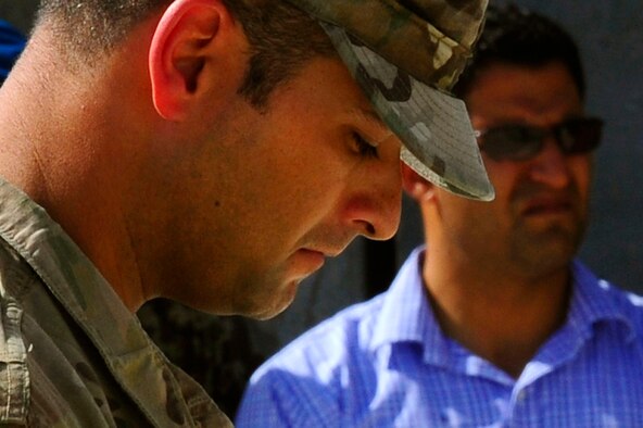 U.S. Air Force Maj. Mike Quirk bows his head for a moment of silence during the September 11 Memorial Ceremony, Sept. 11, 2012 at Kabul Afghanistan, International Airport Afghanistan. The ceremony was to honor those who lost their lives in the September 11 terrorist attacks and the men and women of the Department of Defense fighting the war on terrorism. (U.S. Air Force photo/Tech. Sgt. Quinton Russ/RELEASED)
