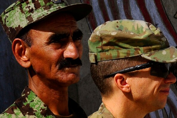 U.S. Air Force Lt. Col. David Eby, right, and a member of the Afghan Air Force member listens to a narrative during the September 11 Memorial Ceremony, Sept. 11, 2012 at Kabul Afghanistan, International Airport Afghanistan. The ceremony was to honor those who lost their lives in the September 11 terrorist attacks and the men and women of the Department of Defense fighting the war on terrorism. (U.S. Air Force photo/Tech. Sgt. Quinton Russ/RELEASED)