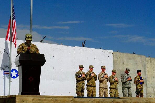 U.S. Air Force Master Sgt. Tammala Lawson reads a narrative while members of the 438th Air Expeditionary Wing holds the flags of their respective nations during the September 11 Memorial Ceremony  Sept. 11, 2012 at Kabul Afghanistan, International Airport Afghanistan. The ceremony was to honor those who lost their lives in the September 11 terrorist attacks and the men and women of the Department of Defense fighting the war on terrorism. (U.S. Air Force photo/Tech. Sgt. Quinton Russ/RELEASED)