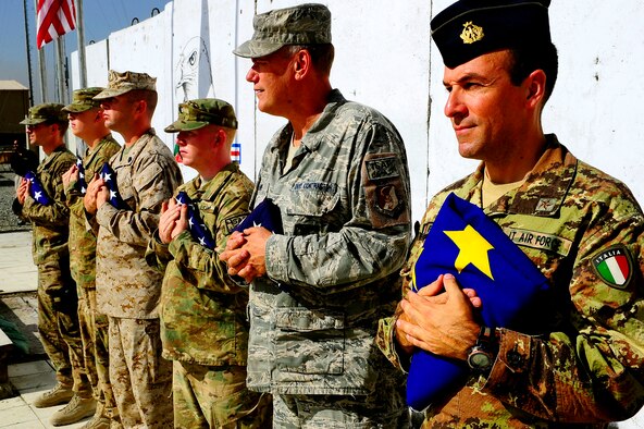 Members of the 438th Air Expeditionary Wing hold their nations flag during the September 11 Memorial Ceremony  Sept. 11, 2012 at Kabul Afghanistan, International Airport Afghanistan. The ceremony was to honor those who lost their lives in the September 11 terrorist attacks and the men and women of the Department of Defense fighting the war on terrorism. (U.S. Air Force photo/Tech. Sgt. Quinton Russ/RELEASED)