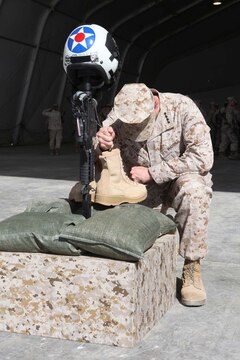 General John Allen, commander of the International Security Assistance Force, pays his final respects to Lt. Col. Christopher Raible during a memorial ceremony, Sept. 19. During the ceremony, Marines paid tribute to Raible, commanding officer of Marine Attack Squadron 211, from Huntingdon, Pa. Raible was killed in action while engaging insurgents during an attack on Camp Bastion, Sept. 14.
