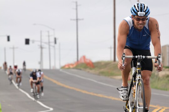 Jon Wieman pulls ahead of a group of competitors during the 56-mile bike ride through base during the Ironman 70.3 Oceanside, Calif. triathlon March 30.  Wieman finished the ride through base in 3-hours, 07-minutes, and 47-seconds. His total finish time for all 70.3-miles was 5:35:42.