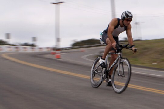 Blake Foster leans into a tight turn during the 56-mile bike ride through base during the Ironman 70.3 Oceanside, Calif. triathlon March 30. Foster finished the ride through base in 2-hours, 36-minutes, and 16-seconds. His total finish time for all 70.3-miles was 4:42:34.