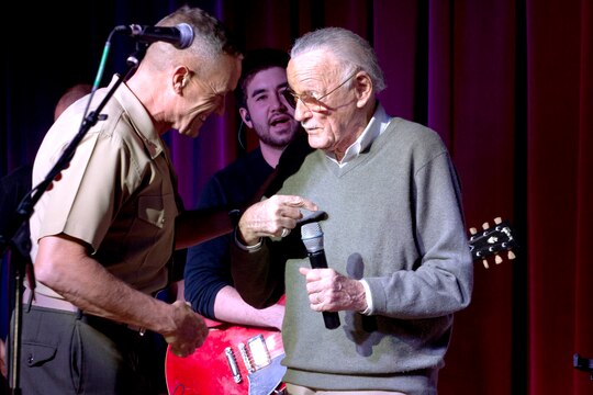 Brig. Gen. Vincent A. Coglianese, left, welcomes Stan Lee, right, to Pendleton during while giving opening remarks during Stan Lee's POW!er Concert at the Pacific Views Event Center here April 5. Coglianese is the base commanding general and regional authority for five military installations in the southwestern United States. Lee is the chairman and chief creative officer of POW! Entertainment.