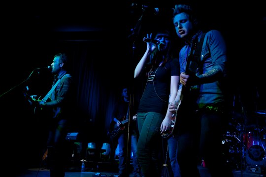 Gloriana performs live at the Pacific Views Event Center here during the premiere of Stan Lee's POW!er Concerts April 5. The band is comprised of Tom Gossin, left, Rachel Reinert, center, and Mike Gossin, right. POW!er Entertainment's mission is to honor and pay tribute to the courageous everyday superheroes of the Armed Forces by bringing live entertainment with a superhero theme to the home front.