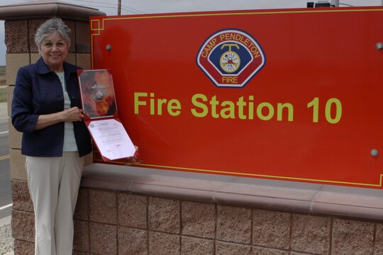 Dorothy Tellez displays a letter from Gen. James F. Amos, commandant of the Marine Corps, which dedicates Pendleton’s Fire Station 10 in honor of Sgt. Brian E. Dunlap here April 6. Dunlap was an advisor for the Iraqi Army and firefighter with the Camp Pendleton Fire Department and in 2005 and was killed by an improvised explosive device while conducting combat operations against enemy forces in Abu Fleiss, Iraq.