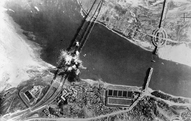 Air view of bombs dropped by U.S. Air Force, exploding on three parallel railroad bridges across Han River, southwest of Seoul, capital of the Republic of Korea. Bridges were bombed early in war to delay advance of invading North Korean troops. (DoD/National Air and Space Museum, #50-9025-306-PS)
