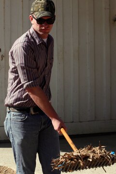 Lance Cpl. Christopher Freel shovels leaves and horse manure during the Single Marine Program’s volunteer event at the Stepp Stables here April 17. Freel is a flight line mechanic with Marine Light Attack Helicopter Squadron 469 here.