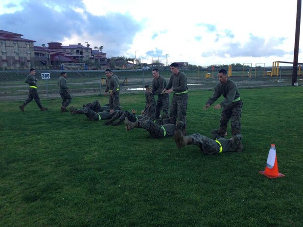 Corporals Leadership Summit 1-13 – Combat Conditioning – Marines attending the Corporals Leadership Summit executing enhanced leg lifts.
