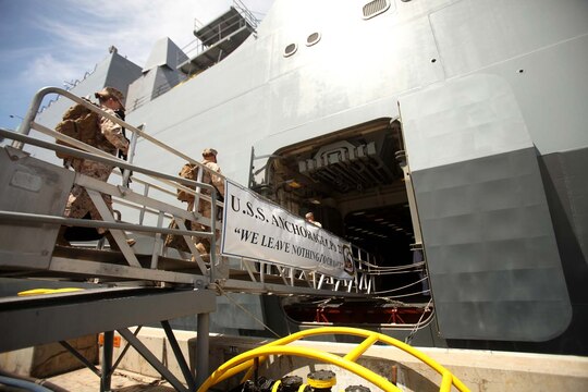 Marines and sailors with 1st Marine Logistics Group, 1st Marine Division and 3rd Marine Aircraft Wing board the Navy's newest amphibious transport dock ship, the USS Anchorage, at Naval Base San Diego, April 21, 2013. The ship left San Diego April 22, and is scheduled to be formally commissioned in Anchorage, Alaska, May 4. (U.S. Marine Corps photo by Cpl. Laura Gauna/Released)