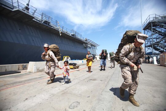Families of Marines and sailors with 1st Marine Logistics Group, 1st Marine Division and 3rd Marine Aircraft Wing accompany their loved ones as they prepare to board the Navy's newest amphibious transport dock ship, the USS Anchorage, at Naval Base San Diego, April 21, 2013. The ship left San Diego April 22, and is scheduled to be formally commissioned in Anchorage, Alaska, May 4. (U.S. Marine Corps photo by Cpl. Laura Gauna/Released)