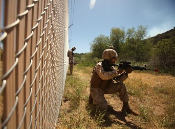 A Marine with 1st Maintenance Battalion, 1st Marine Logistics Group, holds security while on a patrol during the Basic Combat Skills Course aboard Camp Pendleton, Calif., April 18, 2013. Approximately 40 Marines participated in the course designed to refresh Marines in the basics of Marine Corps combat skills to keep them ready for battle.
