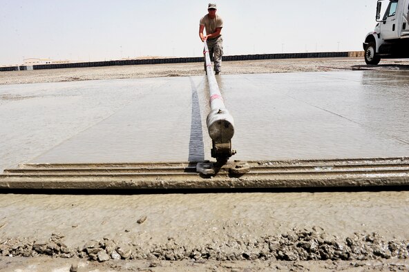 U.S. Air Force Staff Sgt. Jeremy Isaac, 380th Air Expeditionary Wing pavement and construction equipment craftsman, brooms freshly poured concrete at an undisclosed location in Southwest Asia April 16, 2013. There are 20 "Dirt Boyz" responsible for constructing projects that will transition the 380th Air Expeditionary Wing from expeditionary to enduring. Isaac is deployed from Hurlburt Field, Fla. (U.S. Air Force photo by Tech. Sgt. Christina M. Styer)