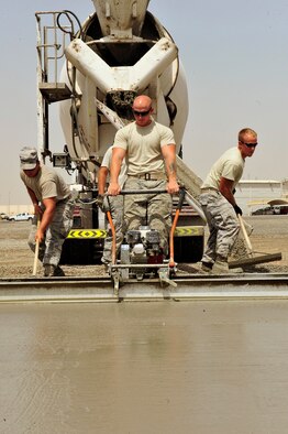U.S. Air Force Airmen assigned to the 380th Expeditionary Civil Engineer Squadron, known as "Dirt Boyz," lay concrete pads at an undisclosed location in Southwest Asia April 16, 2013. The "Dirt Boyz" have dug trenches, poured 96 concrete pads, and set up t-walls, throughout the installation to aid in the 380th Air Expeditionary Wing's transition from expeditionary to enduring. (U.S. Air Force photo by Tech. Sgt. Christina M. Styer) 
