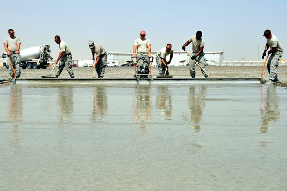 U.S. Air Force Airmen assigned to the 380th Expeditionary Civil Engineer Squadron, known as "Dirt Boyz," lay concrete pads at an undisclosed location in Southwest Asia April 16, 2013. The "Dirt Boyz" have dug trenches, poured 96 concrete pads, and set up t-walls, throughout the installation to aid in the 380th Air Expeditionary Wing's transition from expeditionary to enduring. (U.S. Air Force photo by Tech. Sgt. Christina M. Styer) 
