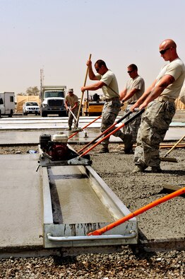 U.S. Air Force Airmen assigned to the 380th Expeditionary Civil Engineer Squadron known as "Dirt Boyz" lay concrete pads at an undisclosed location in Southwest Asia April 16, 2013. There are 20 "Dirt Boyz" responsible for constructing projects that will transition the base from expeditionary to enduring. (U.S. Air Force photo by Tech. Sgt. Christina M. Styer)