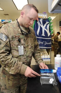 Tech. Sgt. Robert George, 455th Expeditionary Medical Support Squadron pharmacy technician, counts out medication at the Craig Joint Theater Hospital on Bagram Airfield, Afghanistan, April 23, 2013. The pharmacy is the busiest in the Afghanistan area of operations. (U.S. Air Force photo/Staff Sgt. David Dobrydney)