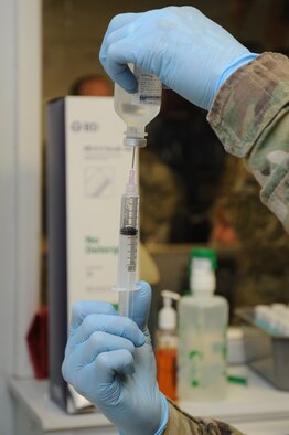 Maj. Fernando Santana, 455th Expeditionary Medical Support Squadron pharmacy flight commander deployed from Joint Base San Antonio, Texas, prepares a syringe for a trauma patient at Craig Joint Theater Hospital on Bagram Airfield, Afghanistan, April 23, 2013. The pharmacy flight is regularly called to provide support in trauma cases in order to allow doctors and nurses to focus on the patient. (U.S. Air Force photo/Staff Sgt. David Dobrydney)