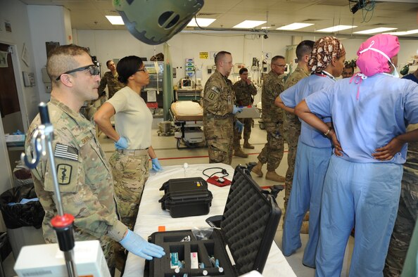 Maj. Fernando Santana, 455th Expeditionary Medical Support Squadron pharmacy flight commander deployed from Joint Base San Antonio, Texas, and Master Sgt. Tammy Robinson, 455th EMDSS pharmacy flight chief deployed from Maxwell Air Force Base, Ala., observe a trauma patient being treated at the Craig Joint Theater Hospital on Bagram Airfield, Afghanistan, April 23, 2013. The pharmacy flight provides medication support in the intensive care unit and operating rooms to allow doctors and nurses to better focus on the patient. (U.S. Air Force photo/Staff Sgt. David Dobrydney)