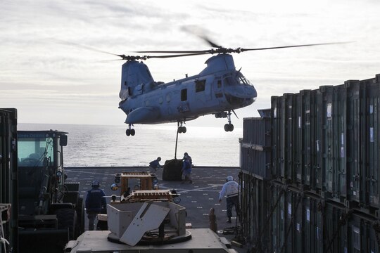 USS RUSHMORE (April 27, 2013) Marines assigned to Transportation Support  Detachment, Combat Logistics Battalion 15, 15th Marine Expeditionary Unit, connect cargo to the bottom of a CH-46E Sea Knight assigned to Marine Medium Helicopter Squadron 364 (Rein.), 15th MEU, during an aerial lift aboard USS Rushmore, April 27. The helicopter support team below conducted a total of seven lifts during the exercise to practice their skills and to refresh the skills of the pilot and crew. The 15th MEU is comprised of approximately 2,400 Marines and sailors and is deployed as part of the Peleliu Amphibious Ready Group. Together, they provide a forward-deployed, flexible sea-based Marine Air Ground Task Force capable of conducting a wide variety of operations ranging from humanitarian aid to combat. (U.S. Marine Corps photo by Cpl. Timothy Childers / Released)
