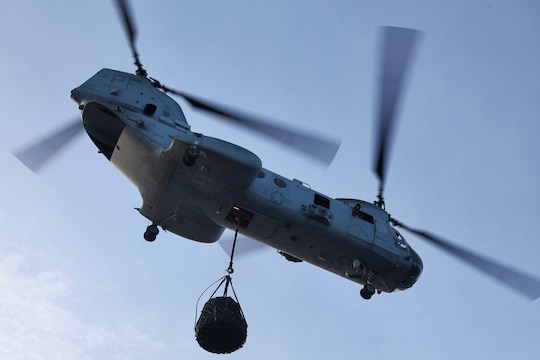130427-M-VZ265-239 USS RUSHMORE (April 27, 2013) A CH-46E Sea Knight assigned to Marine Medium Helicopter Squadron 364 (Rein.), 15th Marine Expeditionary Unit, carries a cargo net after a helicopter support team assigned to Transportation Support  Detachment, Combat Logistics Battalion 15, 15th MEU, conducted an aerial lift aboard USS Rushmore, April 27. The HST below conducted a total of seven lifts during the exercise to practice their skills and to refresh the skills of the pilot and crew. The 15th MEU is comprised of approximately 2,400 Marines and sailors and is deployed as part of the Peleliu Amphibious Ready Group. Together, they provide a forward-deployed, flexible sea-based Marine Air Ground Task Force capable of conducting a wide variety of operations ranging from humanitarian aid to combat. (U.S. Marine Corps photo by Cpl. Timothy Childers / Released)