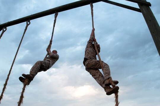 MARINE CORPS BASE CAMP PENDLETON, Calif. – Corporal Bobby J. Gonzalez (left), combat videographer, and Lance Cpl. Ismael E. Ortega, combat photographer, both with Headquarters and Service Company, Headquarters Battalion, 1st Marine Division, climb ropes at the obstacle course at Camp Margarita here, July 26, 2013. Ortega, a native of El Paso, Texas, and Gonzalez, a native of Weslaco, Texas, both deployed to Afghanistan with various units. As members of 1st Marine Division, they must remain physically prepared to attach to units throughout the division.
(U.S. Marine Corps photo by Sgt. Jacob H. Harrer)