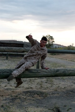 MARINE CORPS BASE CAMP PENDLETON, Calif. – Lance Cpl. Ismael E. Ortega, combat photographer, Headquarters and Service Company, Headquarters Battalion, 1st Marine Division, bounds over a log at the obstacle course at Camp Margarita here, July 26, 2013. Ortega, a native of El Paso, Texas, deployed to Afghanistan with 2nd Battalion, 5th Marine Regiment in support of Operation Enduring Freedom. Marines with Headquarters Battalion often attach to combat arms units for deployments to Afghanistan, so they must maintain a high state of physical readiness. 
(U.S. Marine Corps photo by Sgt. Jacob H. Harrer)