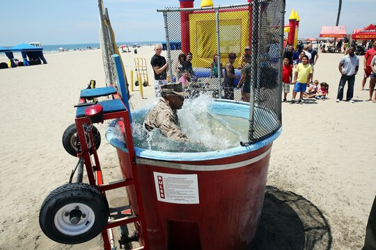Col. Michael E. Cordero sits in the hot seat at the dunk tank where the highest bidder won the opportunity to soak their commanding officer during the Headquarters and Support Battalion, Marine Corps Base Camp Pendleton Family day event held at Del Mar Beach here August 2. Cordero is the commanding officer of Headquarters and Support Battalion, Marine Corps Base Camp Pendleton. The Family Day is held by the battalion to promote camaraderie and a fun environment for the Marines and their family members.