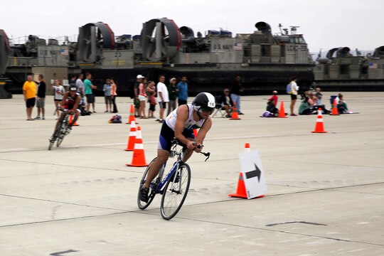 Racers ride into the last leg of the 30 kilometer bicycle portion of the Semper Tri/Devil Dog Duathlon held at Assault Craft Unit-5 here August 3. The Semper Tri/Devil Dog Duathlon is the first event where the Hard Corps Race Series has combined the triathlon and duathlon. Racers are required to swim 500 meters, cycle 30 kilometers, and run 5 kilometers to complete the trial.