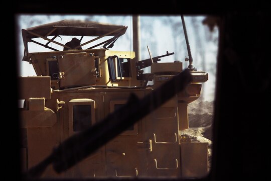 A gunner peers out of his turret during a combat logistics patrol conducted by Transportation Support Company, Combat Logistics Regiment 2, Regional Command (Southwest), in Helmand province, Afghanistan, July 25, 2013. More than 20 vehicles took part in the convoy, which delivered supplies to Marines operating in various forward operating bases throughout the province.