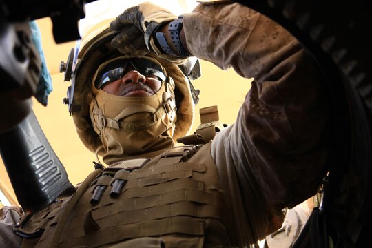 Cpl. Kenneth Benton, a technical controller with Transportation Support Company, Combat Logistics Regiment 2, Regional Command (Southwest), grimaces in his machine-gun turret during a combat logistics patrol in Helmand province, Afghanistan, July 25, 2013. Benton served as a turret gunner during the patrol, which delivered equipment and supplies to Marines serving on forward operating bases in the area around Camp Leatherneck