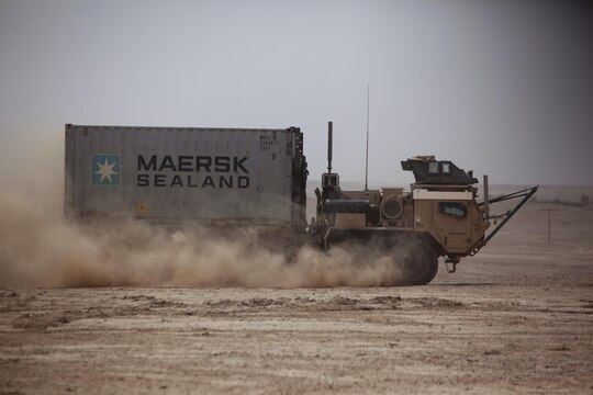 A Logistics System Vehicle Replacement tractor drives through the desert during a combat logistics patrol in Helmand province, Afghanistan, Aug. 4, 2013. The LVSR hauled a shipping container filled with commodities destined for servicemembers operating out of various isolated areas around the province. 