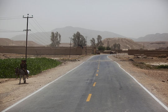 A modern road provides easy passage for vehicles through an Afghan village in Helmand province, Afghanistan. A combat logistics patrol conducted by soldiers with the Army’s 1st Battalion, 26th Infantry Regiment, used the route while supporting a Marine Corps Community Services Marine with Combat Logistics Regiment 2, Regional Command (Southwest), as he provided commodity sales to isolated servicemembers. 
