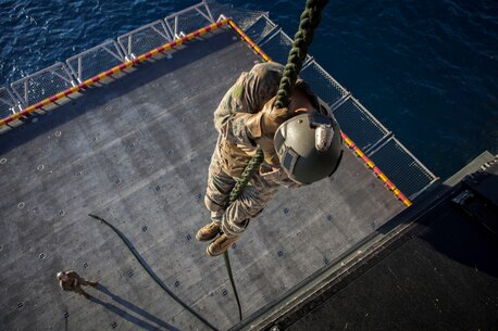 A Marine with the Force Reconnaissance Platoon, Maritime Raid Force, 31st Marine Expeditionary Unit, fast ropes out of a static MV-22 Osprey aircraft onto the elevator below the flight deck here, Aug. 10. The Marines and Sailors hone their skills by training while stationary before descending from an aircraft in flight. The 31st MEU is currently deployed with Amphibious Squadron 11 on a regularly scheduled patrol. The 31st MEU is the Marine Corps’ force in readiness in the Asia-Pacific region and is the only continuously forward deployed MEU.