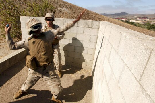 Lance Cpl. Lester Echols chucks an M69 practice grenade from a training bay on Range 109 here. Twenty-four Marines with Marine Air Support Squadron 3 of 3rd Marine Aircraft Wing here conducted live-fire grenade training here. Echols is an air support operator with the support squadron here. 