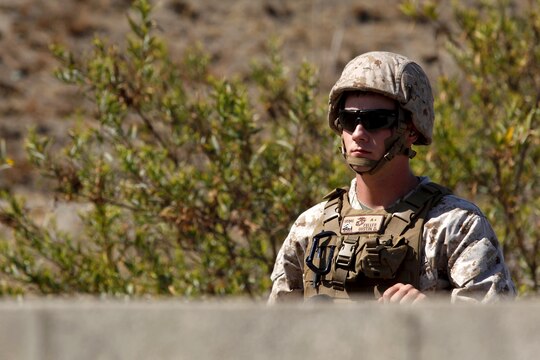 Cpl. Dustin Fuller waits in a practice bay as M69 dummy grenades are distributed to the 24 Marines from Marine Air Support Squadron 3 here who will conduct live-fire grenade training at Range 109 here Aug. 13. Fuller is an air support operator with the support squadron here. 

