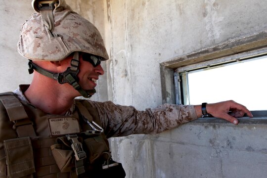 Cpl. Tom Valliant watches M67 Fragmentation Grenades explode through a window in the observation tower of Range 109 here Aug. 13. Twenty-four Marines with Marine Air Support Squadron 3 of 3rd Marine Aircraft Wing here conducted live-fire grenade training here. Valliant is an air support operator with the support squadron here. 

