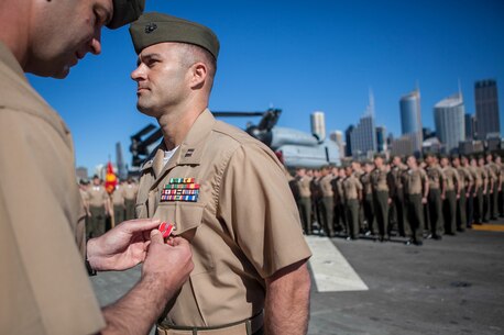 Captain Thaddeus V. Drake Jr., commanding officer of Weapons Company, Battalion Landing Team 2nd Battalion, 4th Marines, 31st Marine Expeditionary Unit, receives the Bronze Star Medal with combat distinguishing device during a ceremony here, Aug. 16. The medal was awarded for heroic actions and decisive combat leadership while in command of Company G., 2nd Battalion, 4th Marine Regiment during Operation Enduring Freedom from September 2011 to March 2012.