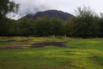 Christopher Stoll, Senior Planner and GIS Specialist with AECOM Naval Facilities Pacific Engineering Command, marks waypoints with a global positioning systems capable camera overlooking Green Beach during a Technical Survey, Pagan, July 30, 2013.  Stoll played a critical role in plotting points and routes of existing roadways, historical markers to enhance and refine existing maps.