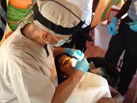 Commander William J. Lyons performs a dental procedure on a patient in Sri Lanka as part of Pacific Angel 2013 on Aug. 5, 2013. Pacific Angel is a joint-service operation that provides health service outreach and civic development programs to different countries around the world (Courtesy Photo)