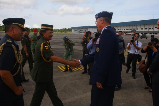 U.S. Air Force Maj. Gen. Paul H. McGillicuddy greets the Sultan of Brunei Haji Hassanal Bolkiah Mu’izzaddin Waddaulah as they begin tours of the U.S. Air Force C-17 Globemaster III, Marine MV-22B Osprey and KC-130J Super Hercules aircraft Dec. 3 at Rimba Air Base, Brunei, during the 4th Biennial Brunei Darussalam International Defense Exhibition and Conference. The five-day event includes displays and demonstrations of military equipment, with the theme of bridging the capability gap. BRIDEX 13 is an opportunity for communication and cooperation with regional partners and allies, builds strong multilateral relationships and enhances preparedness for disasters and other contingency operations. U.S. participation in BRIDEX 13 demonstrates cooperative engagement with Brunei and continued commitment to regional security and stability in the Asia-Pacific region. McGillicuddy is chief of staff, Pacific Air Force.