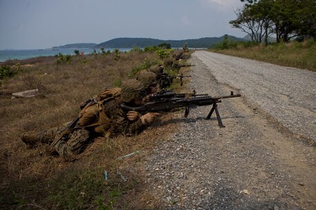 Marines and Sailors with Company A., Battalion Landing Team 1st Battalion, 5th Marine Regiment, 31st Marine Expeditionary Unit, provide security along a road during an amphibious assault for exercise Cobra Gold 2013 here, Feb. 14. Cobra Gold is an annual exercisethat includes numerous multilateral events ranging from amphibious assaults to non-combatant evacuation operations. The training aims to improve interoperability between the United States, the Kingdom of Thailand, and many other participating countries. The 31st MEU is the only continuously forward-deployed MEU and is the Marine Corps’ force in readiness in the Asia-Pacific region.