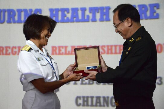 U.S. Navy Rear Adm. Raquel C. Bono, command surgeon, U.S. Pacific Command, left, and Thai Army Lt. Gen. Phanuvich Pumhirun, Royal Thai Army Medical Department, exchanged gifts Feb. 14 at a healthcare symposium in Chiang Mai province, Kingdom of Thailand, during exercise Cobra Gold 2013. The daylong multinational symposium allowed subject matter experts to exchange medical best practices to increase the efficacy of collective efforts to combat dengue fever, melioidosis and other diseases common to Southeast Asia. Exercise Cobra Gold is the largest multinational exercise in the Asia-Pacific region and provides the Kingdom of Thailand, United States, Singapore, Japan, Republic of Korea, Indonesia, Malaysia and observer nations an opportunity to maintain relationships and enhance interoperability.