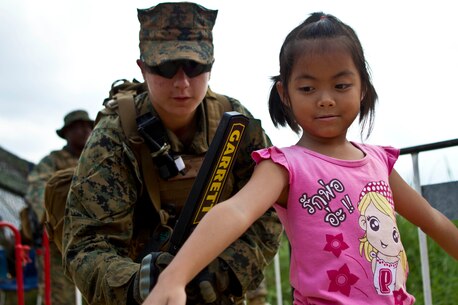 Corporal Elaina M. Rojas, a radio operator with Combat Logistics Battalion 31, 31st Marine Expeditionary Unit, and a native of Kin City, Mo., uses a metal detector to scan a Thai child during a multilateral non-combatant evacuation operation as a part of Cobra Gold 2013 here, Feb. 17. Cobra Gold is the largest multinational exercise in the Asia-Pacific and helps reinforce the foundation and framework for a multinational force to respond rapidly and effectively to regional crises. The 31st MEU is the only continuously forward-deployed MEU and is the Marine Corps’ force in readiness in the Asia-Pacific region.
